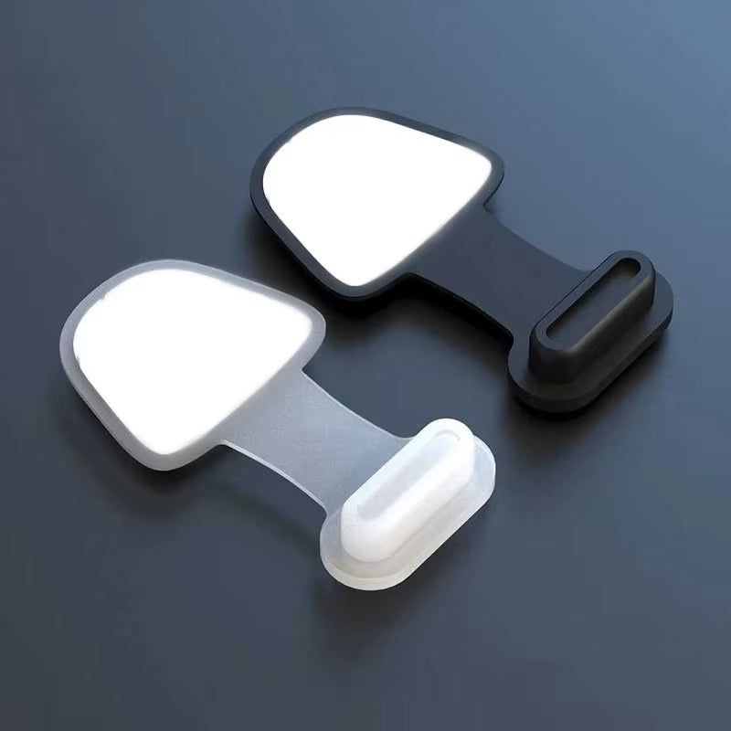 Two black and white phone holders on a dark background